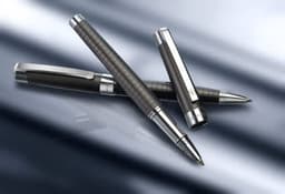 A metal writing set featuring three pens with a sleek black and silver design, including a rollerball and a ballpoint pen.