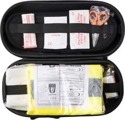 A black first aid kit containing bandages, scissors, and emergency supplies with a bright yellow safety vest.