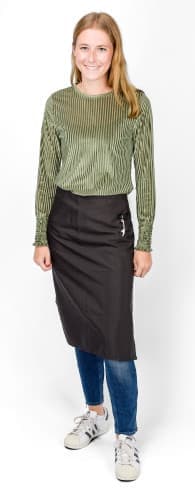 A woman wearing a black polyester apron over a striped green top, standing against a white background.