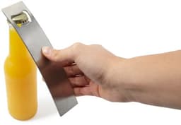 A drink bottle opener made of stainless steel, held above a yellow glass bottle. The opener features a logo.
