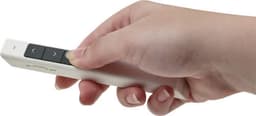 A white ABS laser pointer held in a hand, featuring black buttons for navigation.