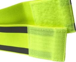 A bright yellow elastane arm band with a textured surface and black stripes, featuring adjustable Velcro closures.