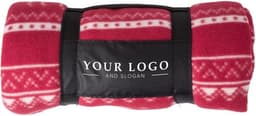 A rolled red polar fleece blanket featuring a festive design and a logo on the black band.