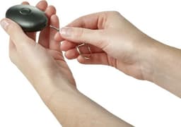 A black ABS personal alarm held in hands, featuring a keyring attachment.