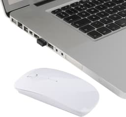 A white ABS optical mouse next to a laptop, showcasing its sleek design. The mouse has a branding logo.