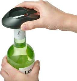A drink bottle opener in black being used on a green wine bottle. The opener features a logo on top.