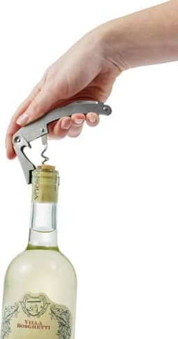 A stainless steel waiter's knife with a corkscrew is being used to open a wine bottle.