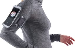 A phone armband in black, securely holding a smartphone, worn on the upper arm of a grey long-sleeve top.