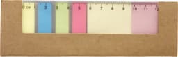 A cardboard sticky note holder containing pastel-coloured sticky notes and a ruler at the top for measuring.