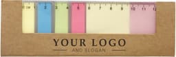 A cardboard sticky note holder with pastel-coloured notes in yellow, green, blue, pink, and cream, featuring a logo.