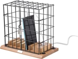 A black wire mobile phone holder with a wooden base, featuring a secured phone and charging cable.