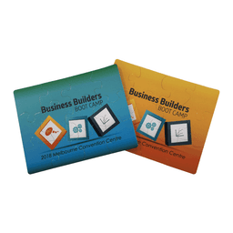 A jigsaw puzzle set featuring two designs, one in blue and the other in orange, with a logo on each piece.
