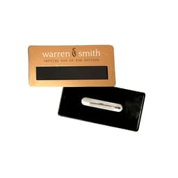 A gold DIY staff badge with a black backing and pin attachment. Features a logo on the front.