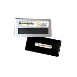 A silver staff badge with an epoxy label and a magnet on the back, featuring a plain black interior.