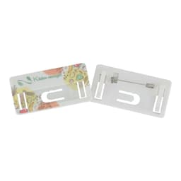 A DIY staff badge in white, featuring a colourful design with a pin on the back. It has a logo present.