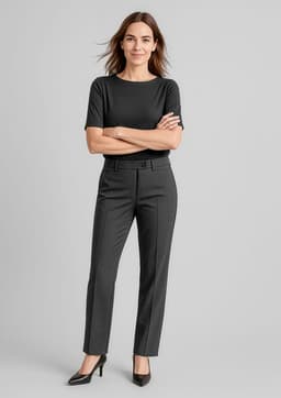 A woman stands confidently in black women's comfort wool stretch relaxed pants and a matching top, with a logo visible.