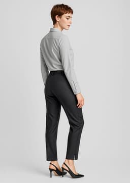 Women’s slim leg pants in dark grey, featuring a sleek design and tailored fit. Styled with a light grey shirt and heels.