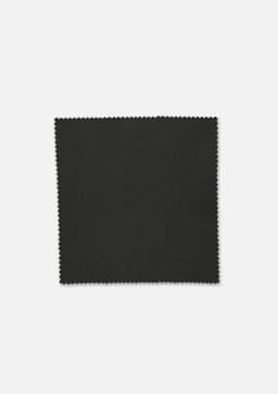 A piece of dark green fabric with a smooth texture and scalloped edges, featuring a subtle sheen.