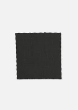 A square swatch of dark grey fabric with a textured finish, featuring a zigzag edge. It has a logo in the corner.