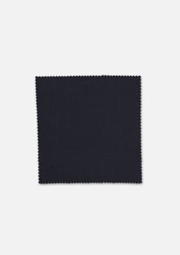 A square swatch of dark navy wool stretch suiting fabric with a textured finish and scalloped edges.