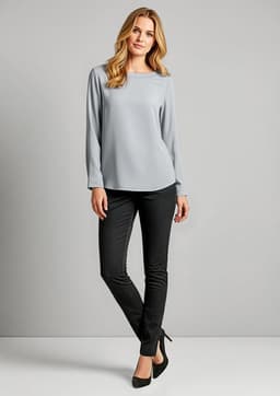 A model wearing grey top and black leggings stands against a plain background. The leggings have a sleek design and a logo.