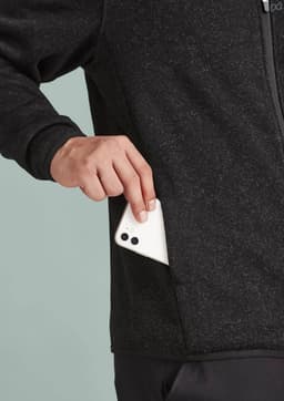A men's zip front jumper in black, featuring a pocket for storage and a logo on the fabric.