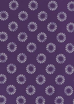 A purple tunic featuring a daisy print pattern in lighter shades. The design includes multiple floral motifs.