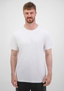 A man stands in a plain white short sleeve tee, featuring a crew neck design and a simple branding logo.