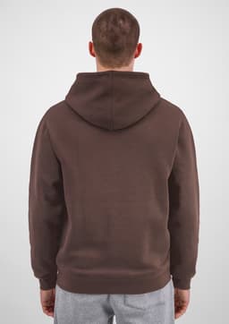 A brown hoodie with a large hood, featuring a plain back view. The model is wearing grey pants.
