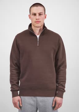 A brown 1/4 zip jumper for men, featuring a collar and ribbed cuffs, displayed on a model.