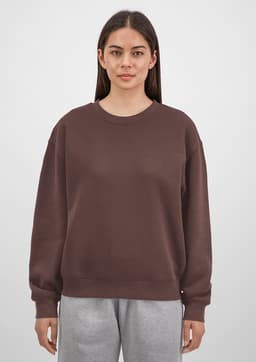 A brown crew sweatshirt for women, featuring a relaxed fit and long sleeves, displayed on a model.