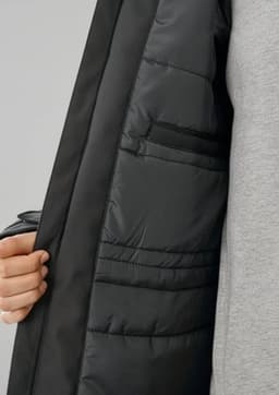 A black unisex rain jacket with a padded interior and inner pockets, showcasing its detailed lining.