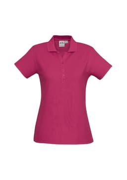 A pink ladies polo shirt with a classic collar, short sleeves, and a button placket. Features a logo on the front.