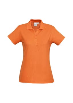 An orange ladies polo shirt with a collar and button placket, featuring a logo on the chest.