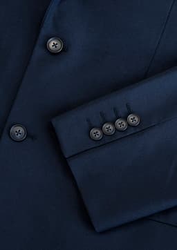 A navy blue jacket featuring a sleek design and buttoned cuffs, with a subtle logo present.