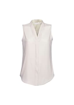 A sleeveless, light cream women's top with a v-neck and soft fabric. Features a branding logo.