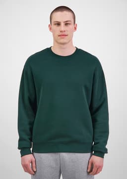 A green men's everyday crew sweatshirt displayed on a model, featured with a plain design and a logo.