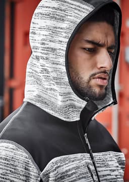 A unisex reinforced knit hoodie in black and grey, featuring a hood and a zip closure, displayed on a model.