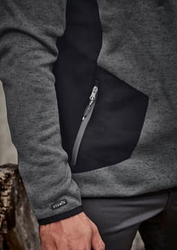 A grey and black unisex pullover featuring a zippered pocket and a logo on the sleeve.