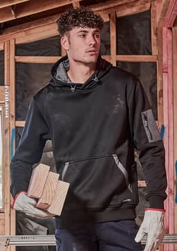 A black unisex water-resistant hoodie with a logo, featuring a front pocket and worn by a model holding wooden blocks.