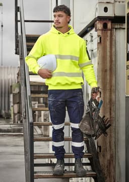 A bright yellow water-resistant hoodie with segmented reflective tape, worn with navy work pants and safety gear.