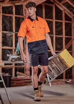 A short sleeve work shirt in hi-vis orange and navy blue, designed for safety and visibility in construction settings.