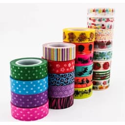 A collection of decorative washi tape rolls in various colours and patterns, including polka dots, stripes, and floral designs.
