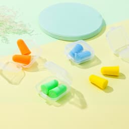 Earplugs in a clear case, featuring orange, green, blue, and yellow earplugs on a light pastel background.