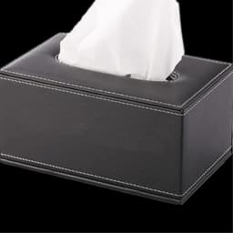 A sleek black leather tissue box with white stitching and a tissue peeking out from the top.