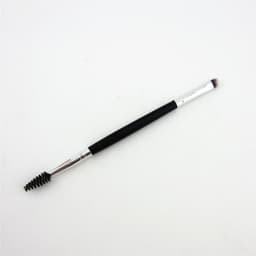 A double-headed eyebrow brush with a black handle, featuring a spoolie brush on one end and a flat brush on the other.