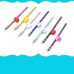 A selection of pet collars with bells in various colours including red, yellow, pink, blue, black, and purple.