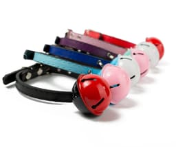 A selection of pet collars in various colours, each featuring a bell at the front.