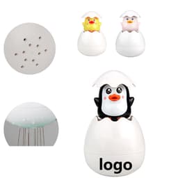 A children's bathroom sprinkler toy shaped like eggs, featuring yellow and pink chicks and a black penguin, all in white.
