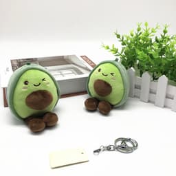 A pair of green avocado plush dolls with brown accents, featuring a keychain attachment.